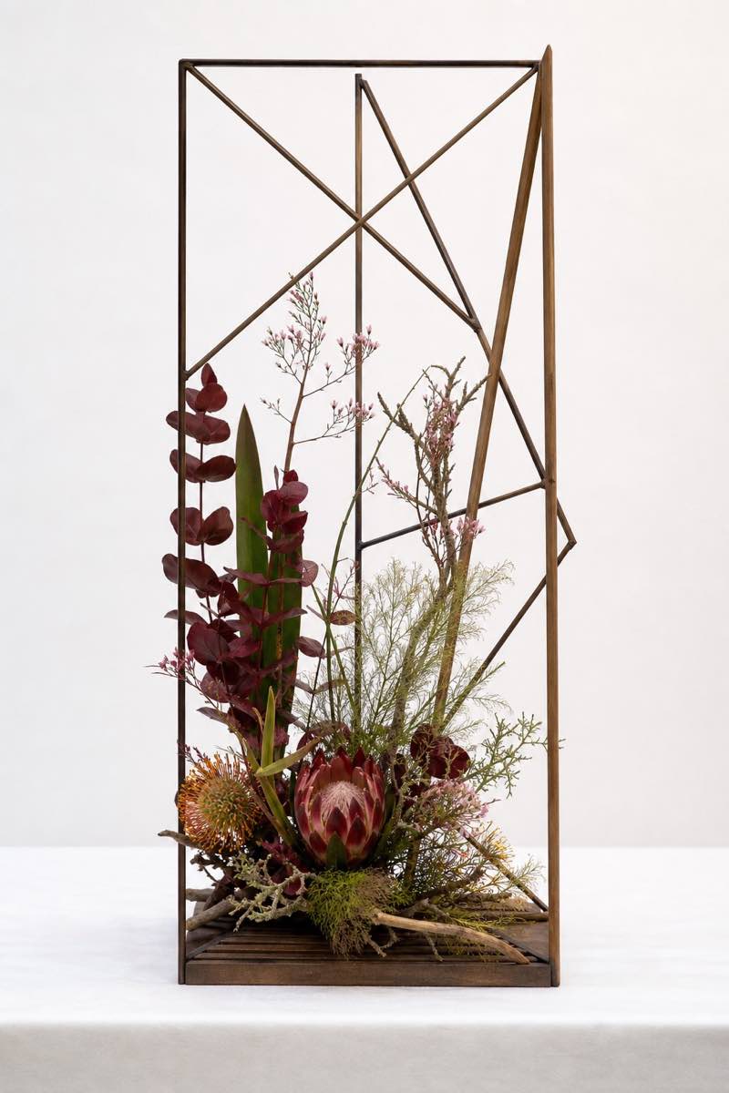 Portrait-format example of a tall Between the lines frame design with proteas, foliage and open negative space.