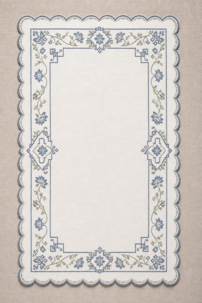 Portrait-format example of a tray cloth with blue and sage-green machine embroidery.